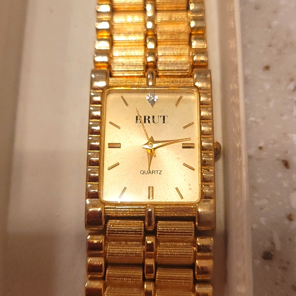 Brut Womans 1" thick gold tone watch.